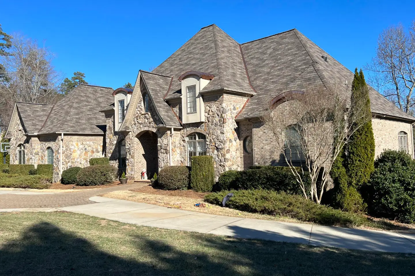 Black architectural shingles with copper accents installed by Redeem Roofing